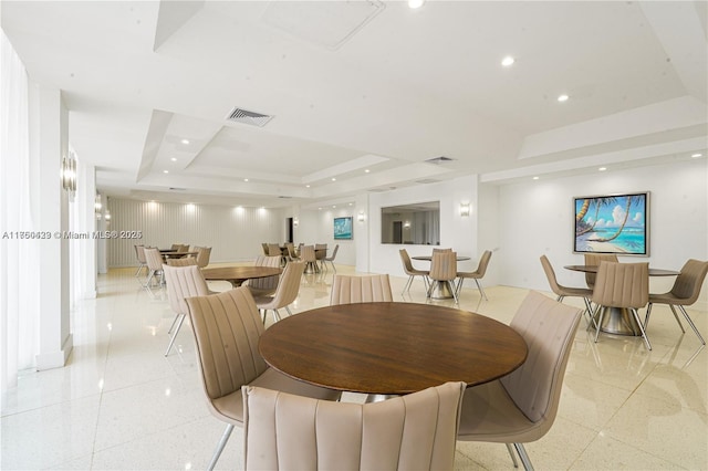 dining room featuring a tray ceiling, recessed lighting, light speckled floor, and visible vents