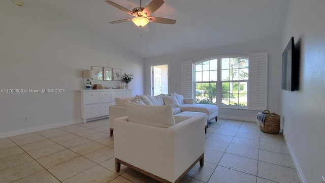 living area with light tile patterned flooring, ceiling fan, baseboards, and lofted ceiling