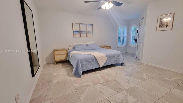 bedroom featuring ceiling fan and baseboards