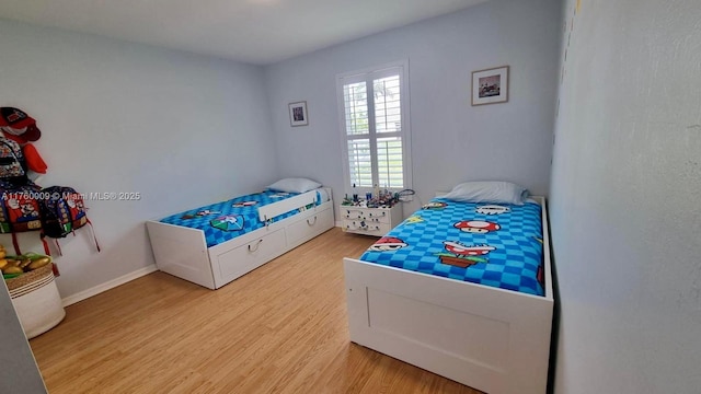 bedroom with light wood-style floors and baseboards