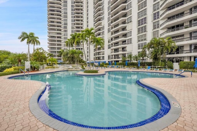 community pool with a patio area