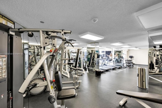 exercise room with a textured ceiling