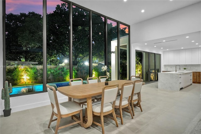 dining room with a wall of windows, light tile patterned flooring, and recessed lighting