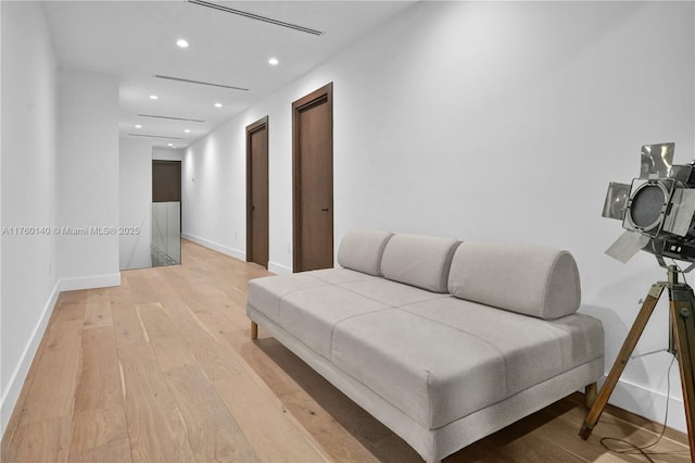 sitting room with light wood-style flooring, recessed lighting, and baseboards