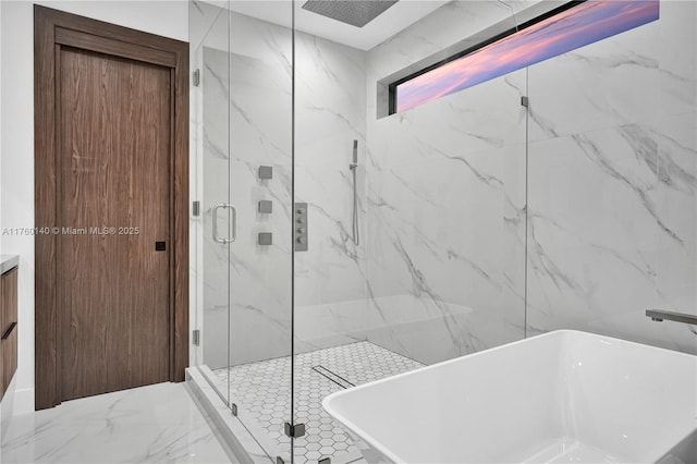 full bath featuring vanity, a freestanding tub, marble finish floor, and a marble finish shower