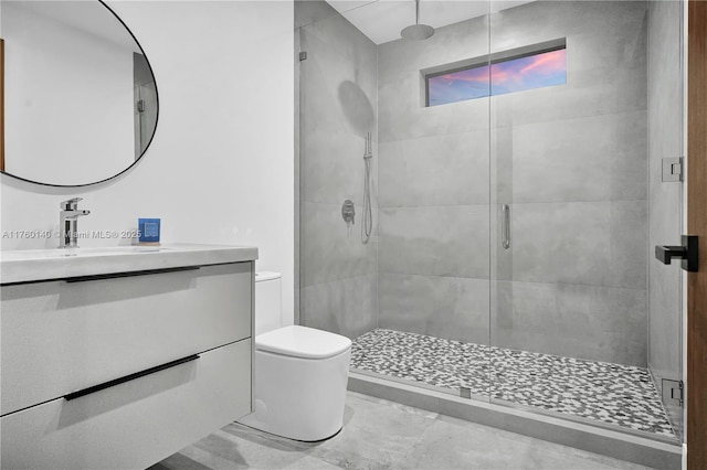 bathroom featuring a stall shower, toilet, and vanity