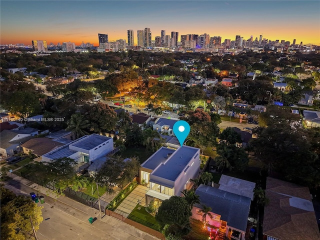 aerial view at dusk featuring a city view