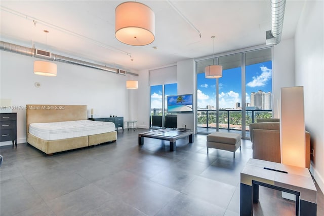 bedroom featuring expansive windows, visible vents, and access to exterior