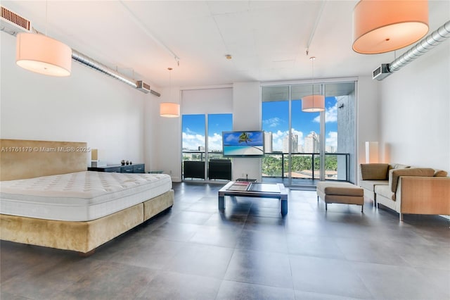 bedroom featuring rail lighting, visible vents, and expansive windows