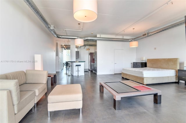 bedroom with visible vents and concrete floors