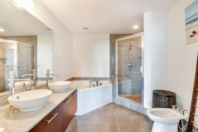 full bath with a stall shower, a bidet, and a sink