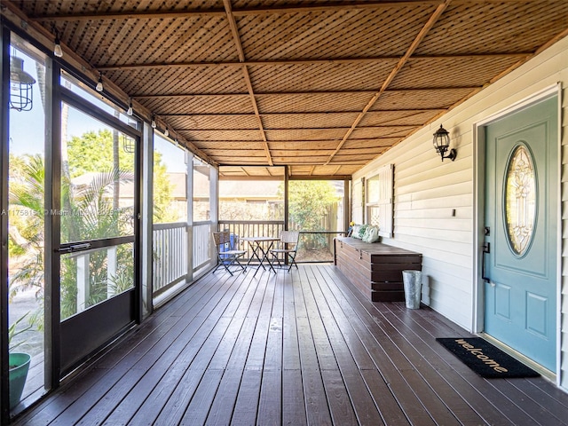 unfurnished sunroom with plenty of natural light