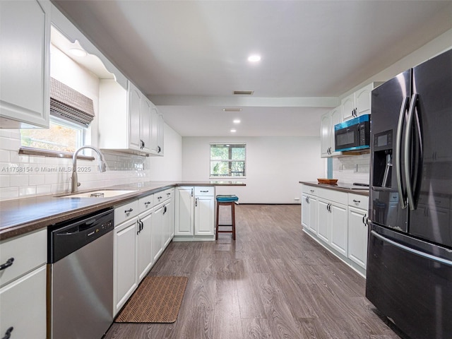 1735 18th St, Vero Beach, FL 32960 - kitchen featuring appliances with stainless steel finishes, a peninsula, a sink, white cabinetry, and recessed lighting