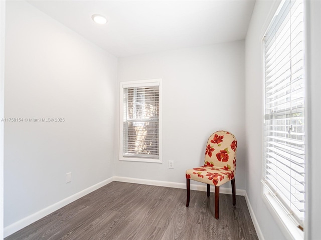 living area with dark wood-style floors and baseboards