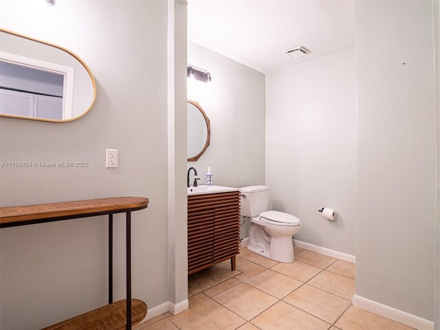 1735 18th St, Vero Beach, FL 32960 - bathroom featuring toilet, tile patterned floors, vanity, and baseboards