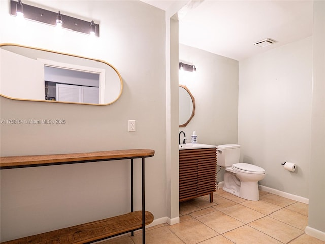 bathroom with visible vents, baseboards, toilet, tile patterned floors, and vanity