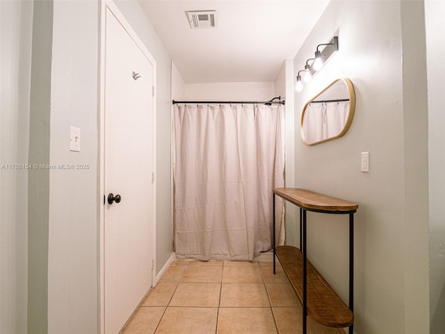 bathroom featuring tile patterned flooring, visible vents, and a shower with curtain