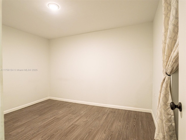 empty room with wood finished floors and baseboards