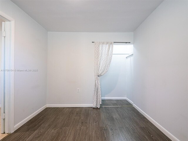 1735 18th St, Vero Beach, FL 32960 - empty room featuring dark wood-style floors and baseboards