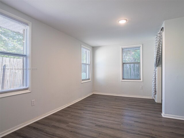 1735 18th St, Vero Beach, FL 32960 - unfurnished room with healthy amount of natural light, dark wood-style floors, and baseboards