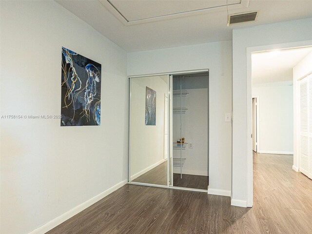 1735 18th St, Vero Beach, FL 32960 - unfurnished bedroom featuring wood finished floors, baseboards, and a closet