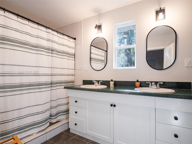 full bath with a sink, a shower with shower curtain, double vanity, and tile patterned floors