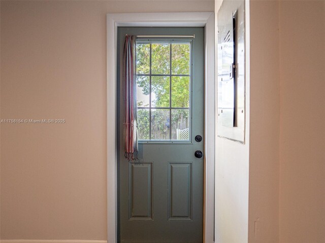 1735 18th St, Vero Beach, FL 32960 - doorway to outside featuring baseboards