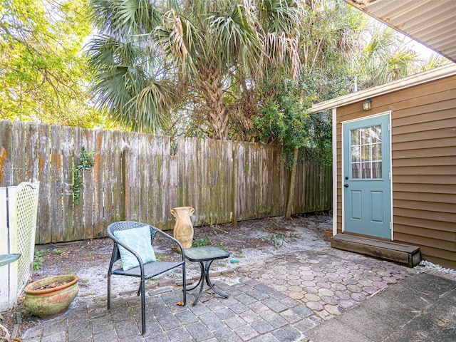 view of patio with an outdoor structure and a fenced backyard