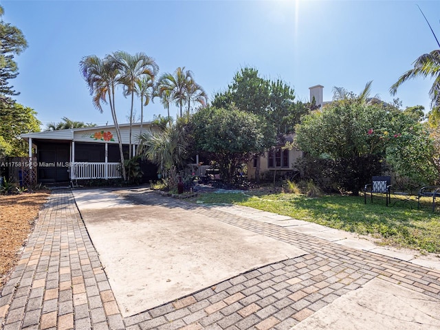 1735 18th St, Vero Beach, FL 32960 - view of front of house with concrete driveway and a front lawn