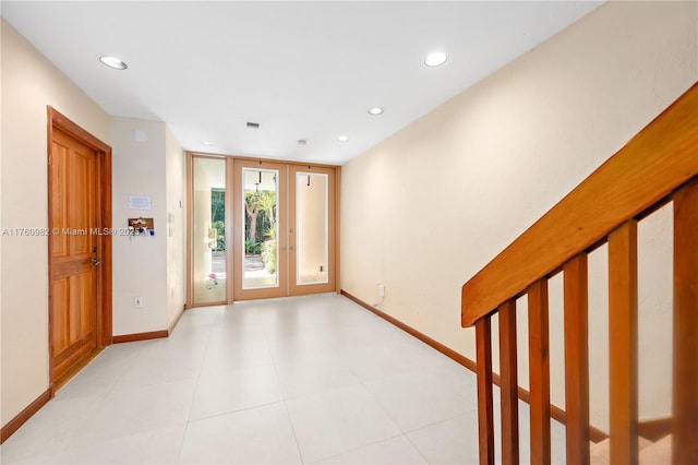 spare room with light tile patterned floors, recessed lighting, french doors, and baseboards