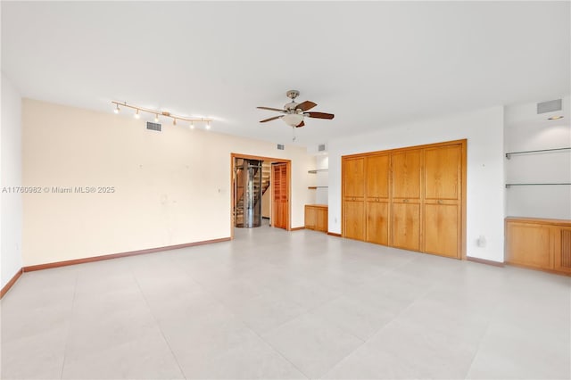 spare room featuring visible vents, baseboards, and a ceiling fan