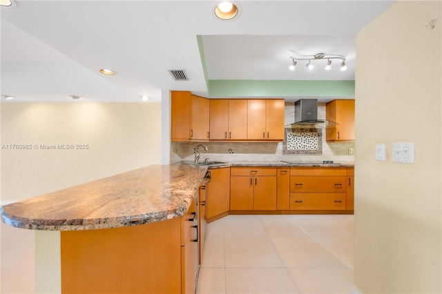 kitchen featuring light tile patterned floors, visible vents, wall chimney exhaust hood, black electric cooktop, and backsplash