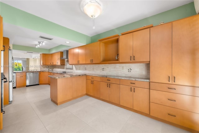 kitchen with tasteful backsplash, visible vents, a peninsula, stainless steel appliances, and wall chimney exhaust hood