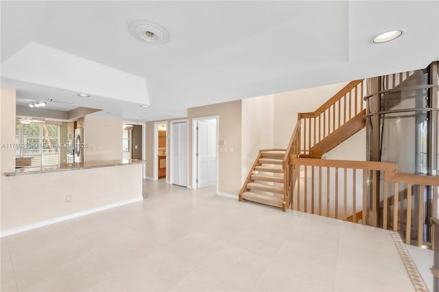 unfurnished living room with stairway, recessed lighting, and baseboards