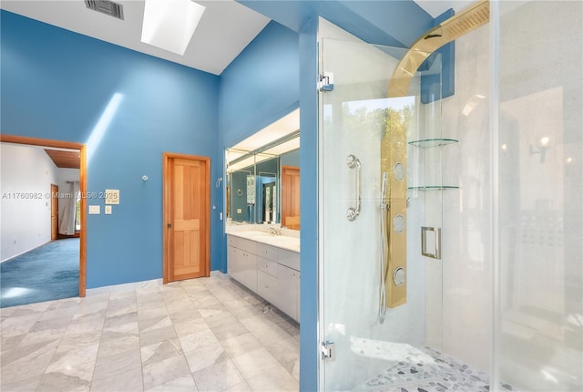 full bathroom with visible vents, a stall shower, a skylight, a towering ceiling, and vanity