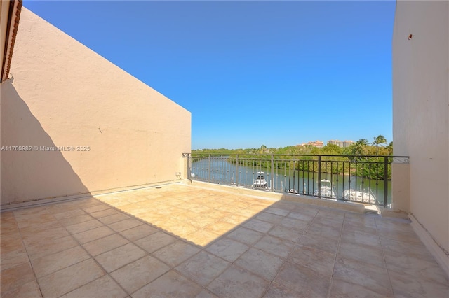 view of patio featuring a balcony and a water view