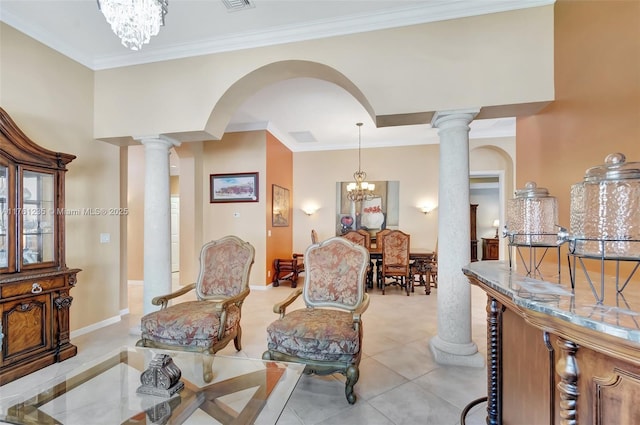 interior space with crown molding, baseboards, arched walkways, a notable chandelier, and ornate columns