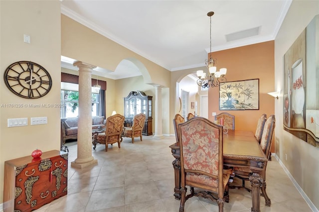 dining room with visible vents, crown molding, baseboards, arched walkways, and ornate columns