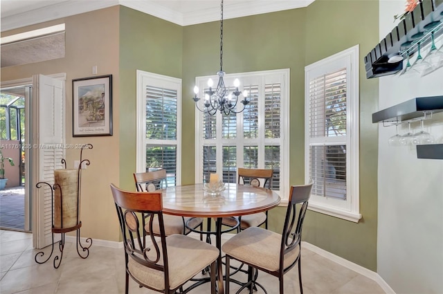 dining space featuring baseboards, a notable chandelier, light tile patterned flooring, and ornamental molding