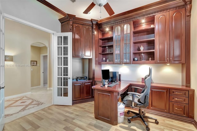 office area featuring french doors, arched walkways, ceiling fan, and light wood finished floors