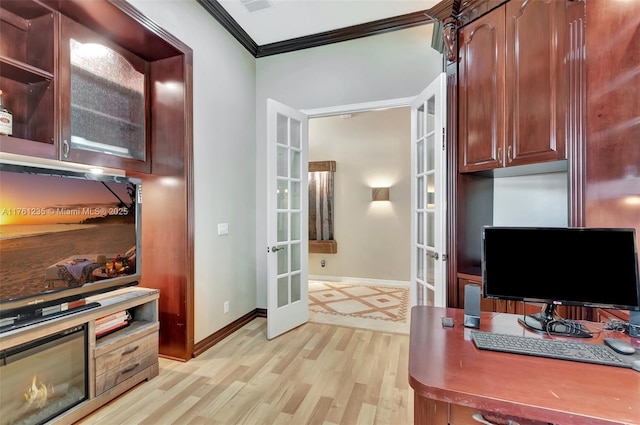 office area with light wood-type flooring, french doors, baseboards, and ornamental molding