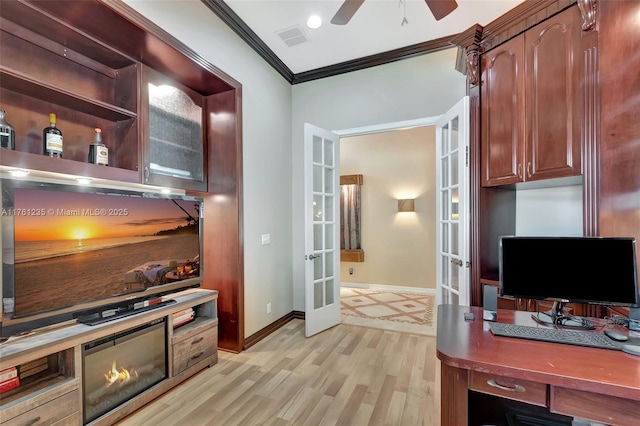 interior space featuring light wood finished floors, visible vents, baseboards, ornamental molding, and french doors