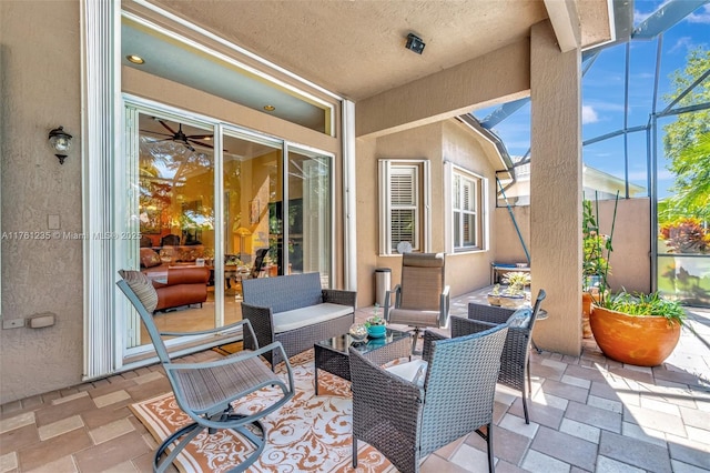 view of patio featuring an outdoor living space and glass enclosure