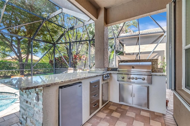 view of patio / terrace with a lanai and area for grilling