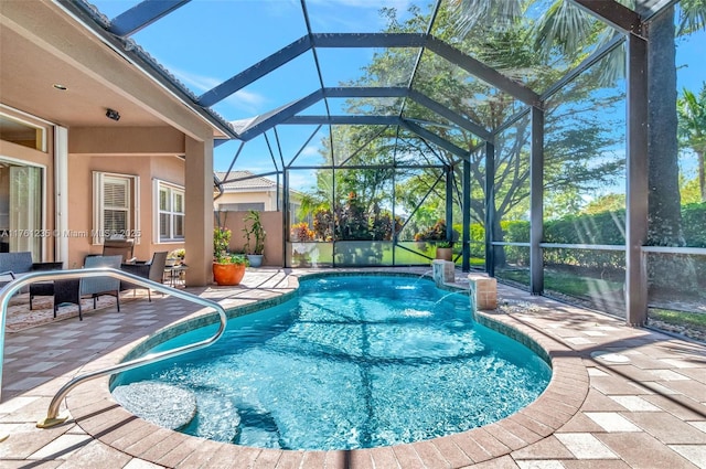 outdoor pool with glass enclosure and a patio area