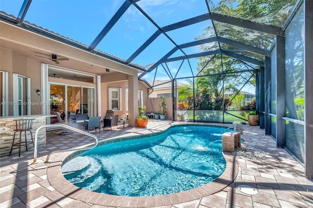 outdoor pool with a patio and a lanai