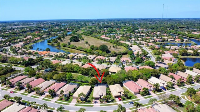 drone / aerial view with a residential view and a water view