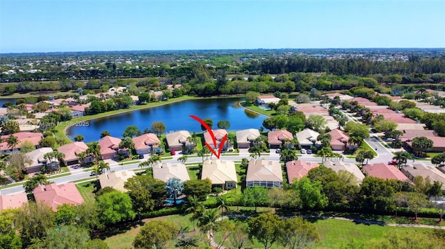 drone / aerial view with a residential view and a water view