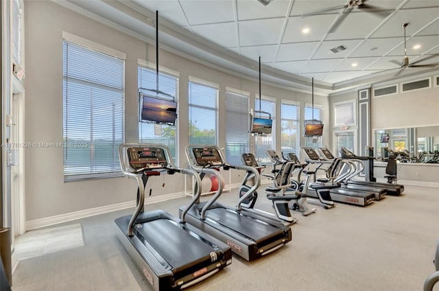 exercise room featuring a high ceiling, baseboards, visible vents, and carpet floors