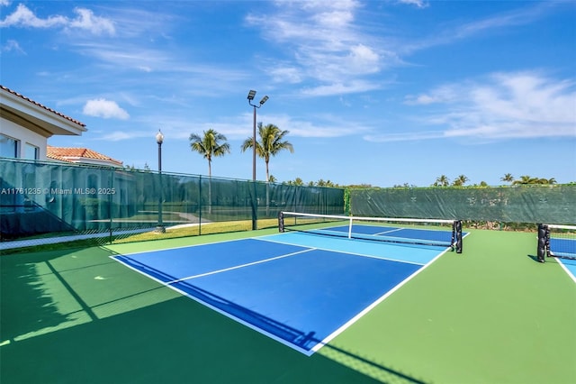 view of sport court with fence